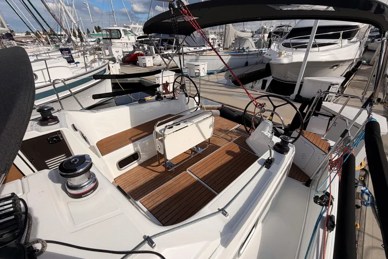Slide: The Image of 2025 Jeanneau Sun Odyssey 350 sailboat with sleek deck design at marina. - 39