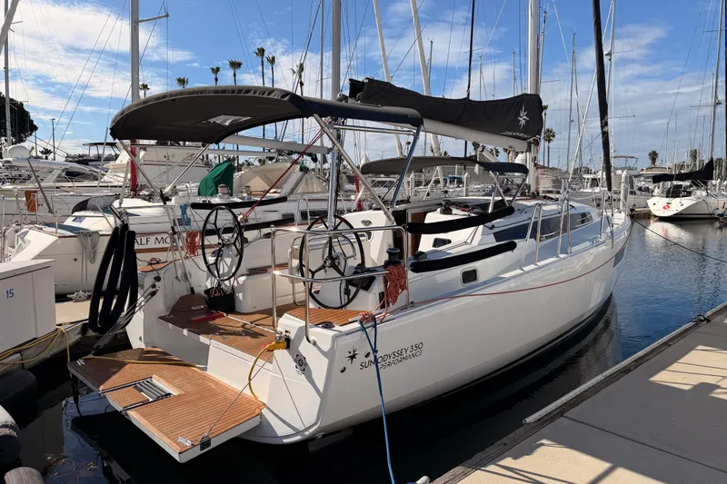 Slide: The Image of 2025 Jeanneau Sun Odyssey 350 sailboat docked in marina under clear blue sky. - 5