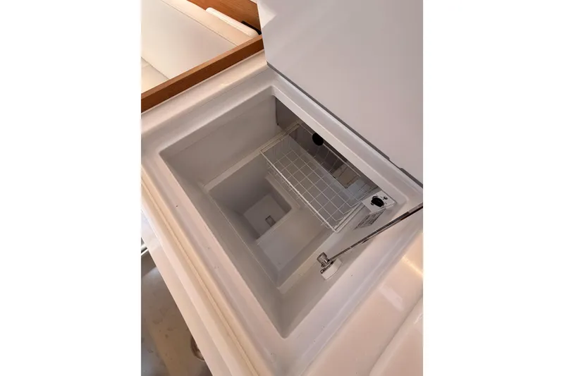 Slide: The Image of Interior view of Jeanneau Sun Odyssey 350 yacht's built-in storage compartment, 2025 model. - 58