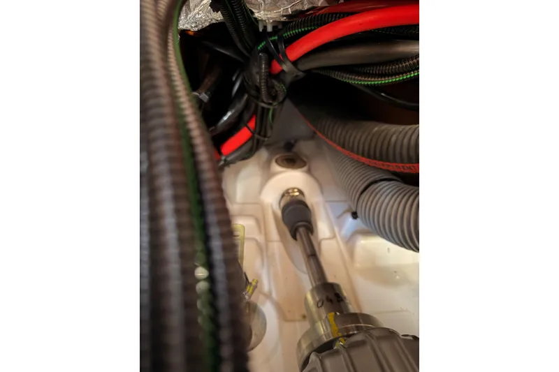 Slide: The Image of Engine compartment of 2025 Jeanneau Sun Odyssey 350 sailboat, showing cables and components. - 93