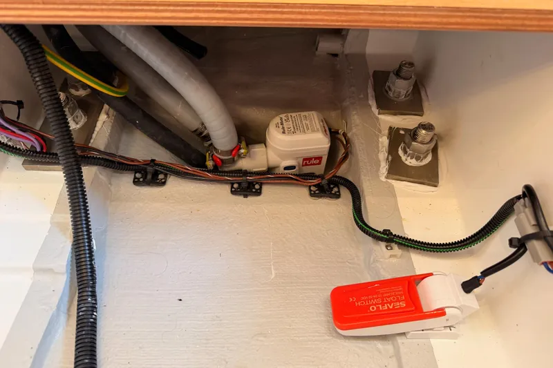 Slide: The Image of Bilge area of 2025 Jeanneau Sun Odyssey 350 with wiring and float switch. - 97