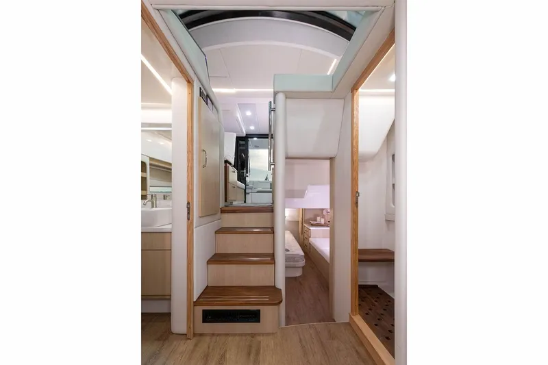 Slide: The Image of Manufacturer Provided Image: Interior view of 2026 Regal 38 Fly yacht, featuring modern stairs and elegant wood finishes. - 11
