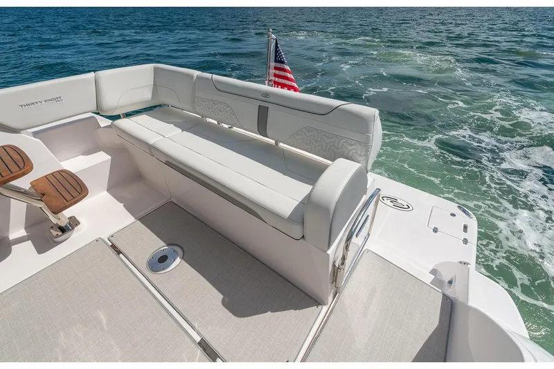 Slide: The Image of Manufacturer Provided Image: 2026 Regal 38 Fly yacht with elegant seating and American flag on open water. - 5
