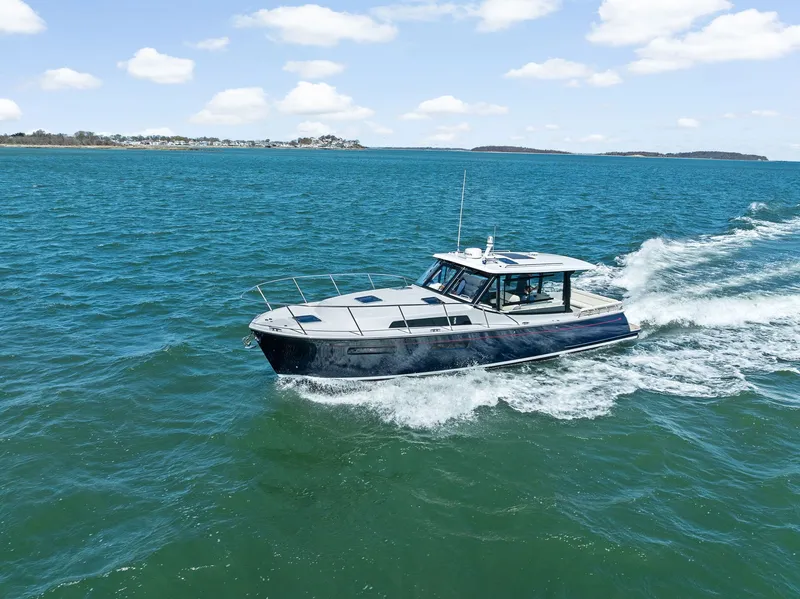 Slide: The Image of MJM 42 Yacht 2025 cruising on open sea under sunny skies. - 0