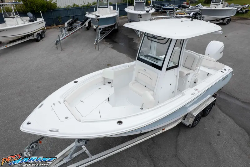 Slide: The Image of 2026 Sea Hunt Ultra 235 SE boat on trailer in a marina setting. - 10