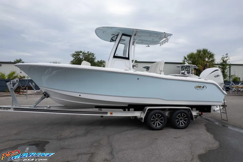Slide: The Image of 2026 Sea Hunt Ultra 235 SE boat on trailer, side view, light blue hull. - 11