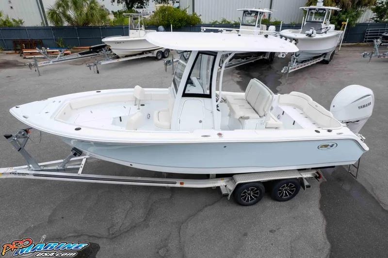 Slide: The Image of 2026 Sea Hunt Ultra 235 SE boat on trailer, parked outdoors. - 13