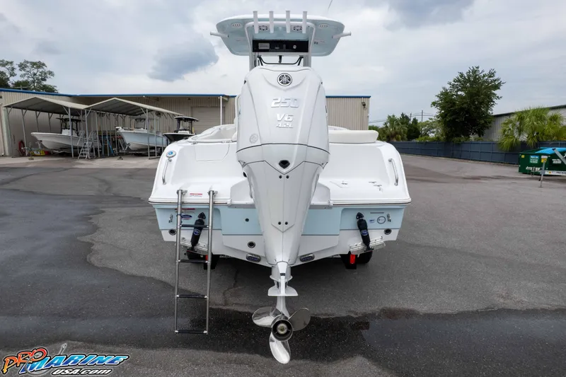 Slide: The Image of 2026 Sea Hunt Ultra 235 SE boat with powerful V6 engine, parked outdoors. - 16