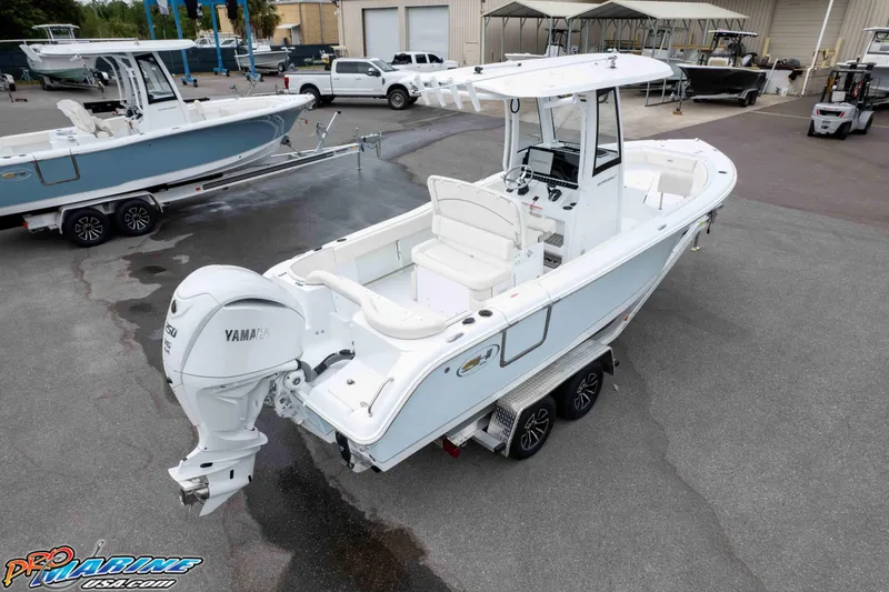 Slide: The Image of 2026 Sea Hunt Ultra 235 SE boat with Yamaha engine on trailer in marina setting. - 20