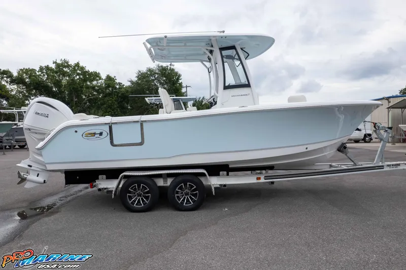 Slide: The Image of 2026 Sea Hunt Ultra 235 SE boat on trailer, featuring sleek design and Yamaha engine. - 21