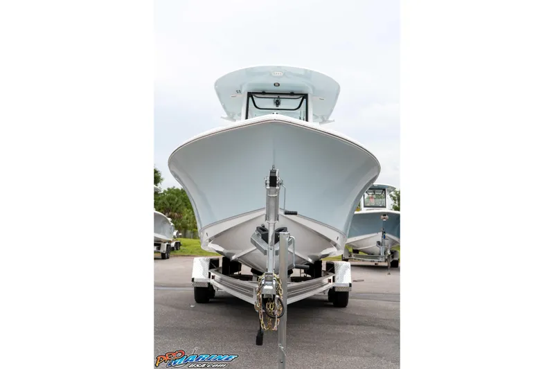 Slide: The Image of 2026 Sea Hunt Ultra 235 SE boat on trailer, front view, parked outdoors. - 27