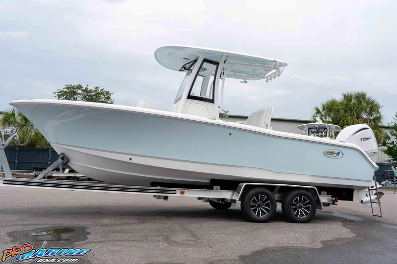 Slide: The Image of 2026 Sea Hunt Ultra 235 SE boat on trailer, side view, outdoors. - 30