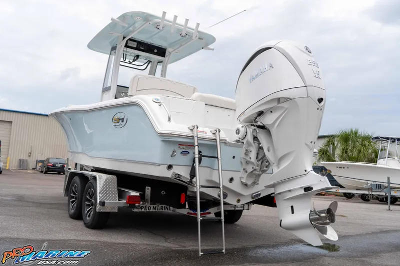 Slide: The Image of 2026 Sea Hunt Ultra 235 SE boat on trailer, featuring powerful outboard motor. - 31
