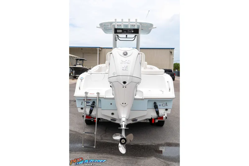 Slide: The Image of 2026 Sea Hunt Ultra 235 SE boat rear view with outboard motor and ladder. - 32