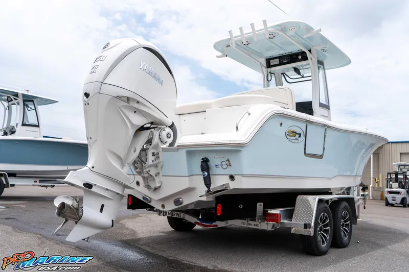 Slide: The Image of 2026 Sea Hunt Ultra 235 SE boat with Yamaha engine on trailer, displayed outdoors. - 33