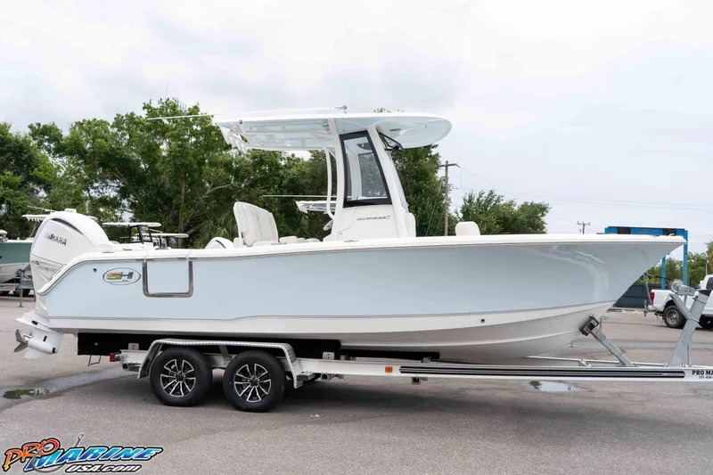Slide: The Image of 2026 Sea Hunt Ultra 235 SE boat on trailer, side view, outdoors. - 35