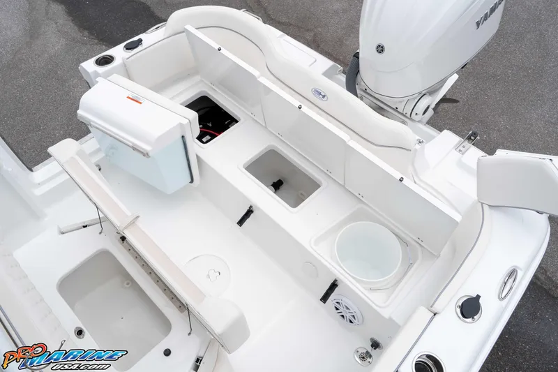 Slide: The Image of 2026 Sea Hunt Ultra 235 SE boat interior with storage compartments and Yamaha engine. - 37