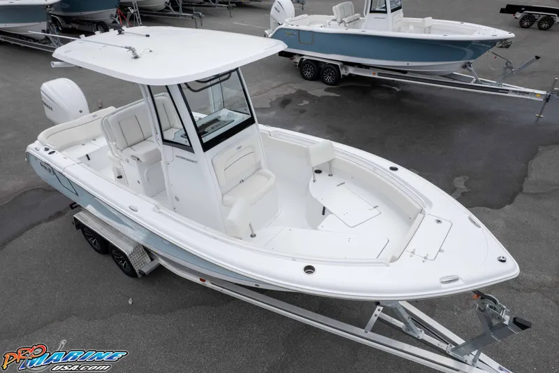 Slide: The Image of 2026 Sea Hunt Ultra 235 SE boat on trailer, white exterior, parked in a lot. - 4