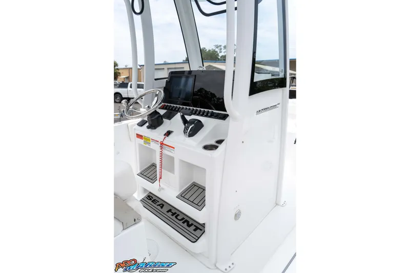Slide: The Image of 2026 Sea Hunt Ultra 235 SE boat console with steering wheel and controls. - 40