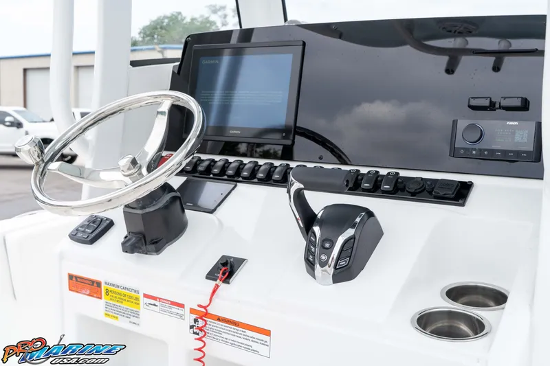 Slide: The Image of Helm of 2026 Sea Hunt Ultra 235 SE with steering wheel and control panel. - 41