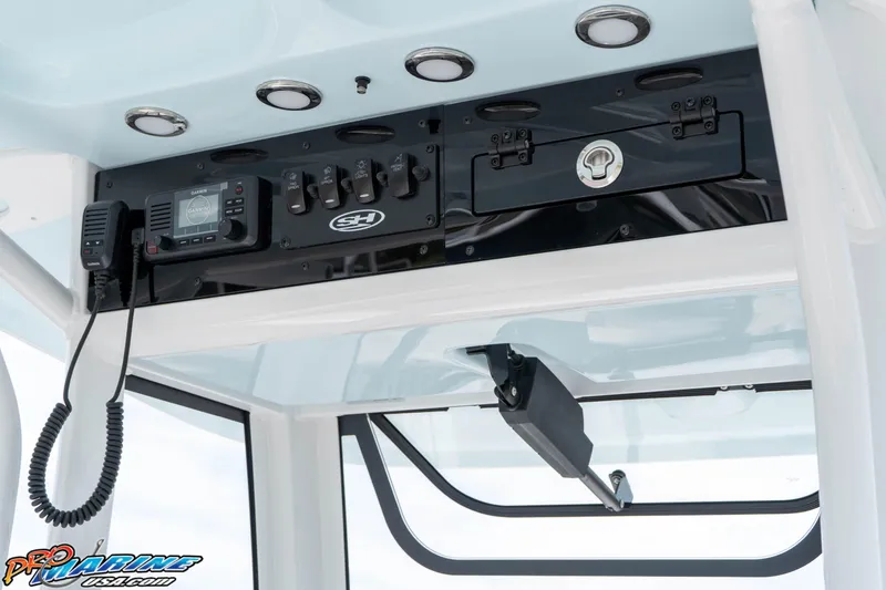 Slide: The Image of 2026 Sea Hunt Ultra 235 SE boat console with controls and radio equipment. - 42