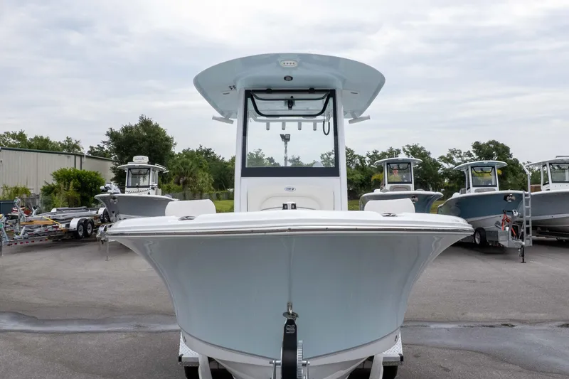 Slide: The Image of 2026 Sea Hunt Ultra 235 SE boat displayed in a marina setting. - 5