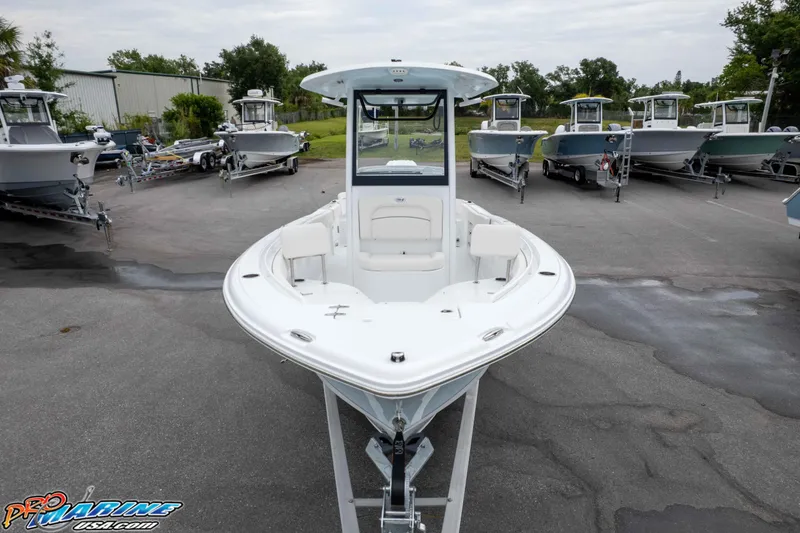 Slide: The Image of 2026 Sea Hunt Ultra 235 SE boat displayed in a marina with multiple vessels. - 6