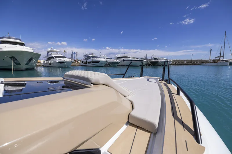 Slide: The Image of 2026 Highfield ADV9 boat docked in marina, surrounded by luxury yachts under clear blue sky. - 11
