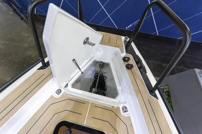 Slide: The Image of Open storage compartment on 2026 Highfield ADV9 boat deck with visible anchor chain. - 12