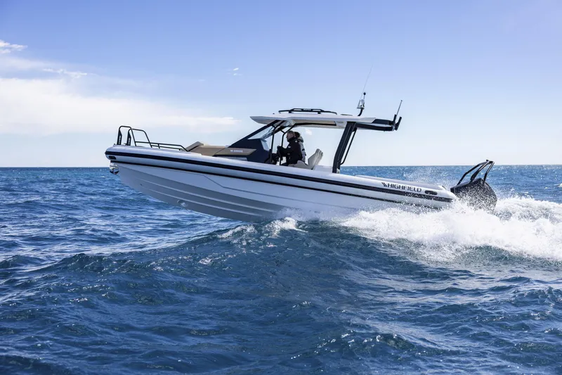 Slide: The Image of 2026 Highfield ADV9 boat navigating ocean waves under clear blue sky. - 13