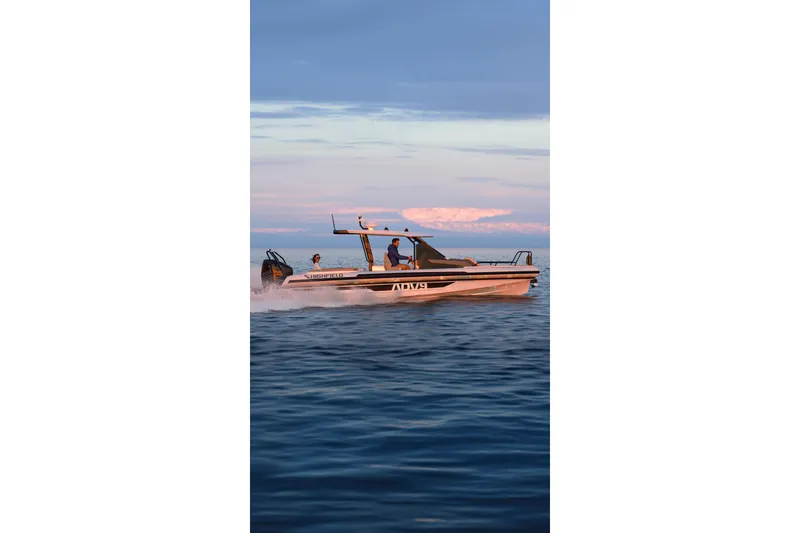Slide: The Image of 2026 Highfield ADV9 boat cruising on calm ocean waters at sunset. - 14