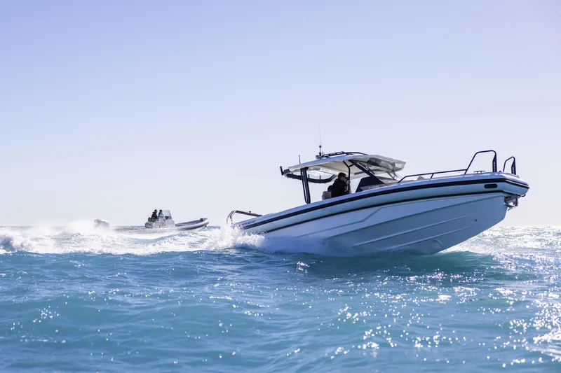 Slide: The Image of 2026 Highfield ADV9 boat cruising on open water under clear skies. - 2