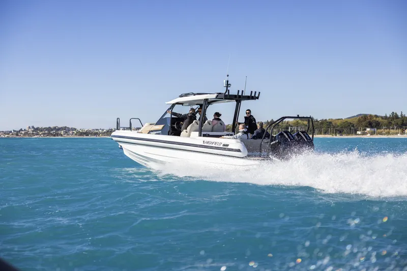 Slide: The Image of 2026 Highfield ADV9 boat cruising on clear blue water under a sunny sky. - 3