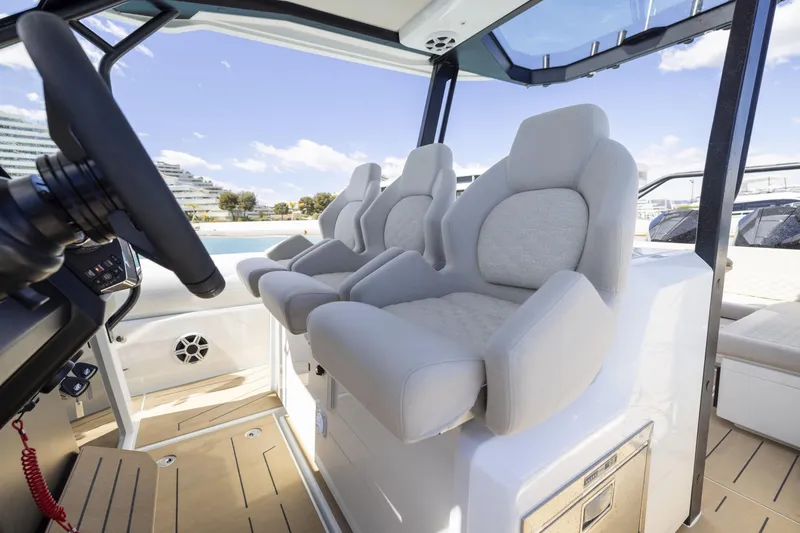 Slide: The Image of Interior of 2026 Highfield ADV9 boat with modern seating and steering wheel. - 6