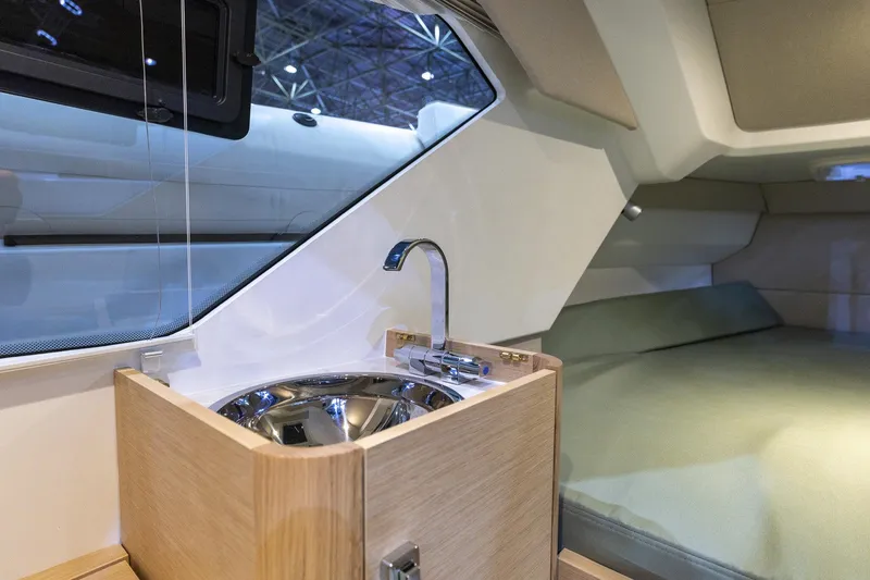 Slide: The Image of Interior of 2026 Highfield ADV9 boat featuring a compact sink and cozy sleeping area. - 9