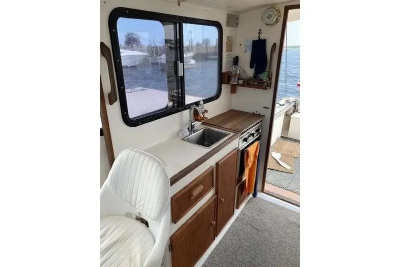 Slide: The Image of Interior of 1988 Duffy 31 Lobster Boat with kitchenette and window view. - 11