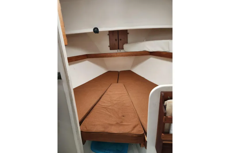 Slide: The Image of 1988 Duffy 31 Lobster Boat cabin interior with brown cushions and wooden accents. - 12
