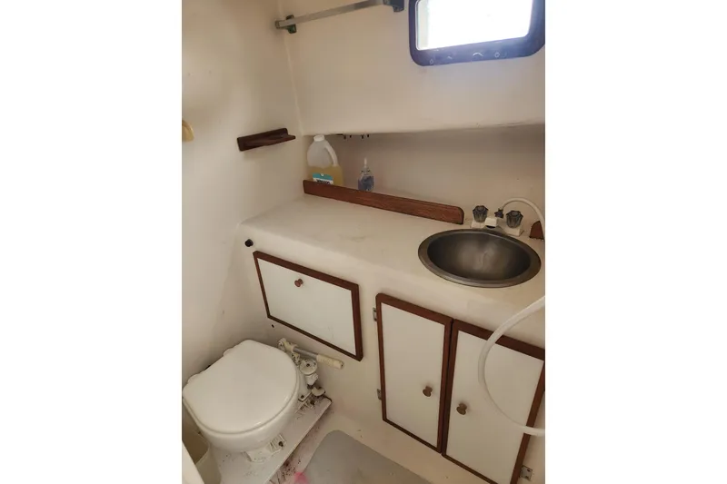 Slide: The Image of 1988 Duffy 31 Lobster Boat bathroom with sink, toilet, and storage cabinets. - 13