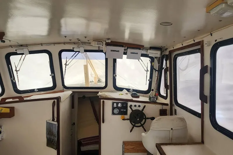 Slide: The Image of Interior of a 1988 Duffy 31 Lobster Boat with steering wheel and navigation equipment. - 7