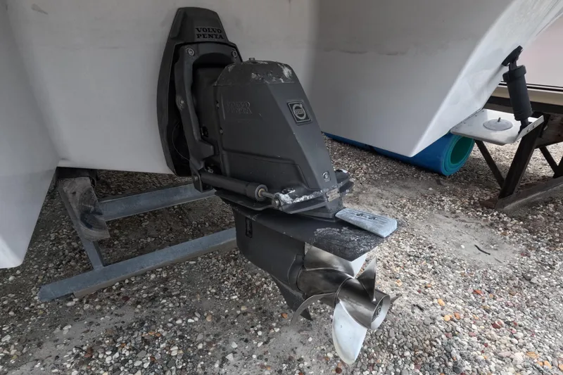 Slide: The Image of 2012 Four Winns V265 boat with Volvo Penta outdrive on gravel surface. - 10