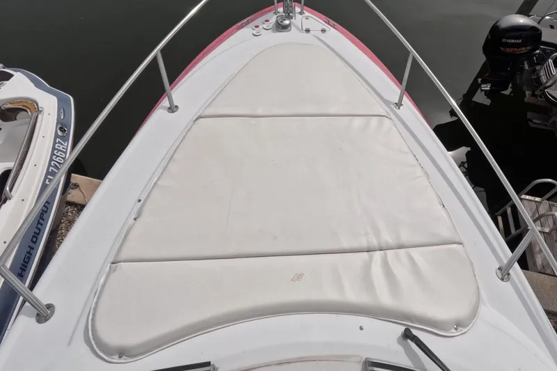 Slide: The Image of Bow view of 2012 Four Winns V265 boat with cushioned deck area. - 14