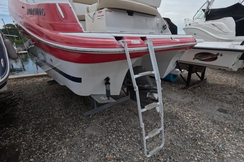 Slide: The Image of 2012 Four Winns V265 boat with ladder, docked on gravel. - 19