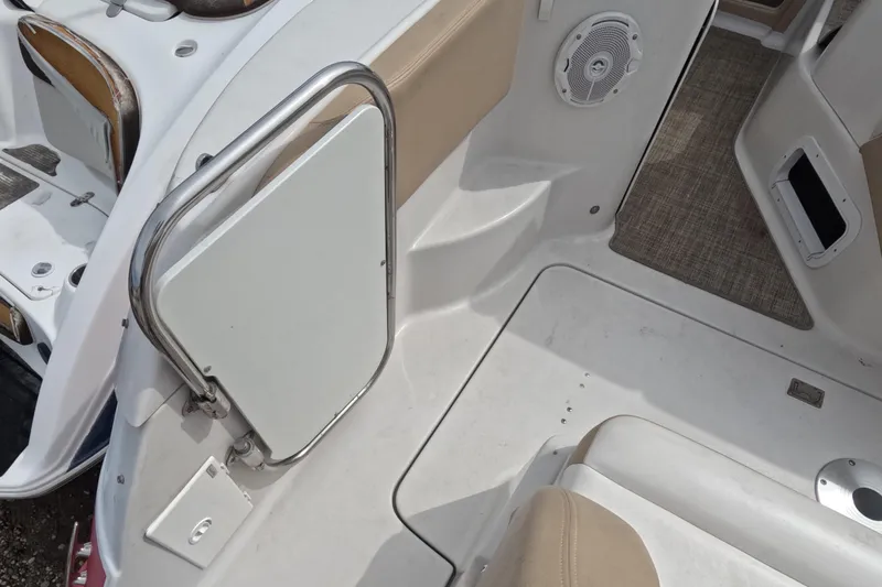 Slide: The Image of 2012 Four Winns V265 boat interior with beige seating and speaker detail. - 25
