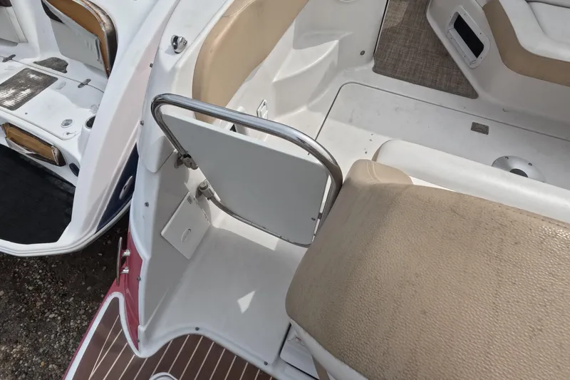 Slide: The Image of 2012 Four Winns V265 boat interior with beige seating and white deck. - 26