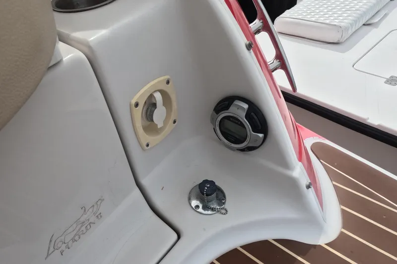 Slide: The Image of 2012 Four Winns V265 boat dashboard with controls and audio system. - 28