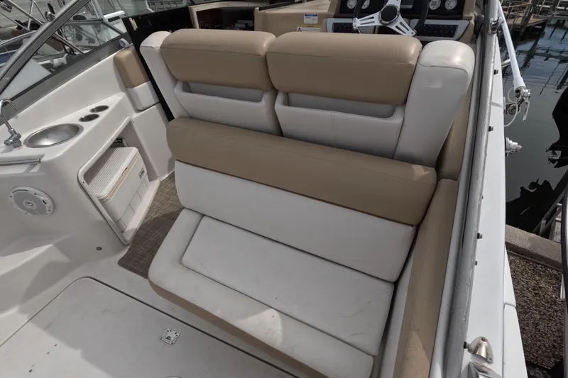 Slide: The Image of 2012 Four Winns V265 boat interior with beige seating and compact kitchenette. - 30