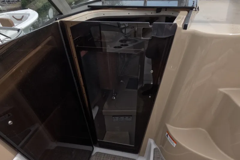 Slide: The Image of 2012 Four Winns V265 cabin entrance with sleek glass door and interior view. - 43