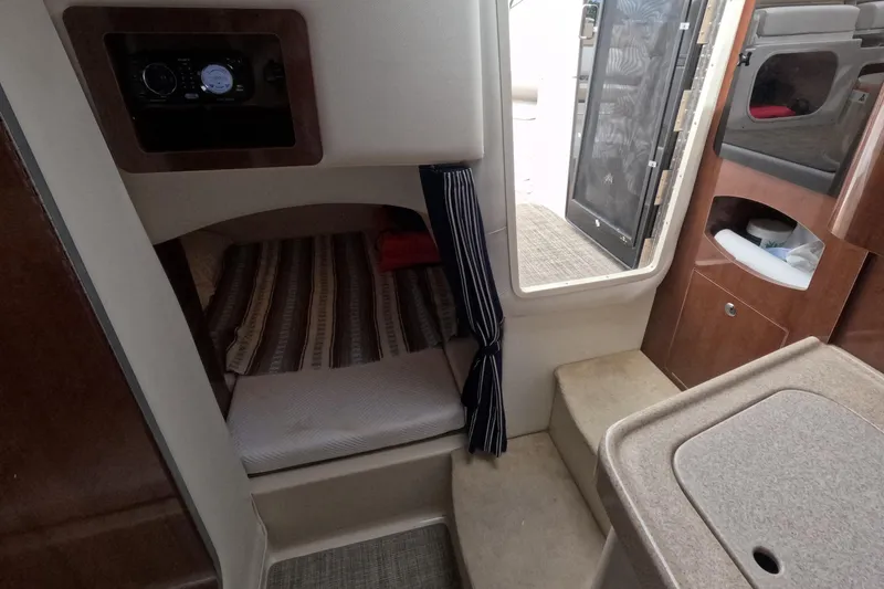 Slide: The Image of Interior cabin of 2012 Four Winns V265 boat with cozy sleeping area. - 48
