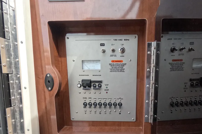 Slide: The Image of Electrical control panel on a 2012 Four Winns V265 boat, featuring switches and gauges. - 49