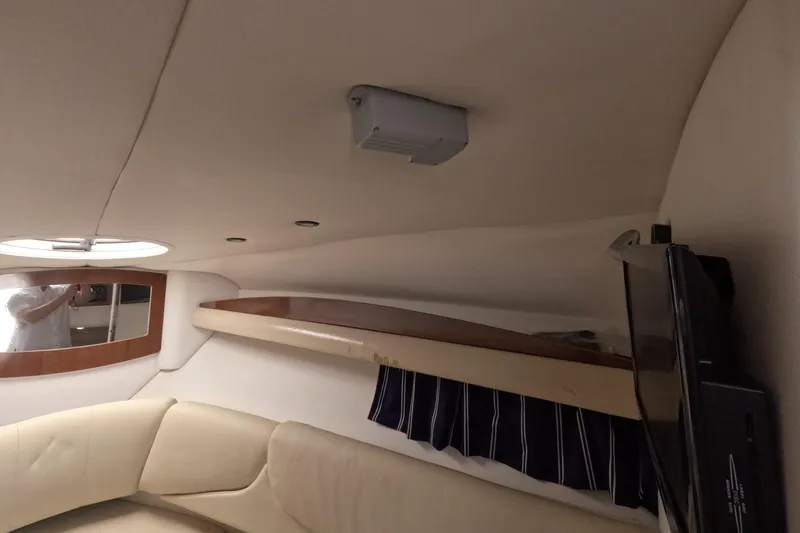 Slide: The Image of Interior cabin of 2012 Four Winns V265 boat with seating and porthole. - 55